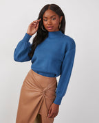 Blue mock neck sweater with long sleeves, showing high neckline and textured knit fabric.
