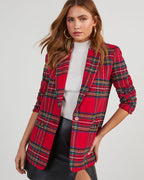 Women’s red plaid blazer with padded shoulders, open front, long sleeves over a white top.