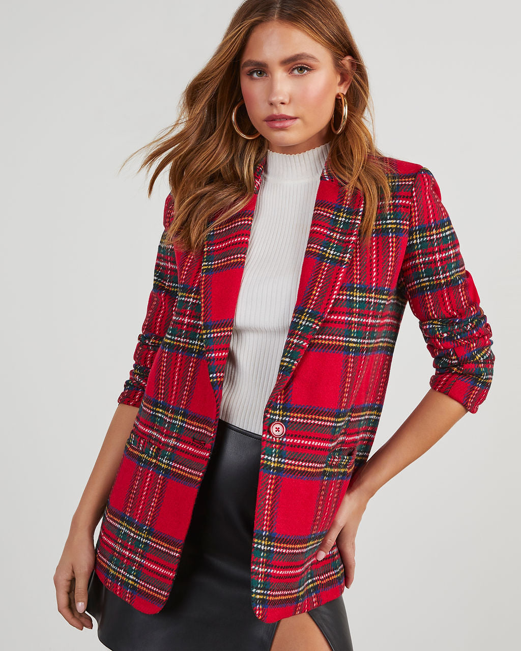 Women’s red plaid blazer with padded shoulders, open front, long sleeves over a white top.