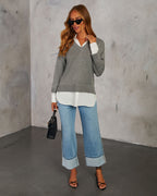 Grey V-neck pullover sweater with white contrast shirt hem; long sleeves