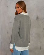Grey V-neck pullover sweater with white contrast shirt hem; long sleeves