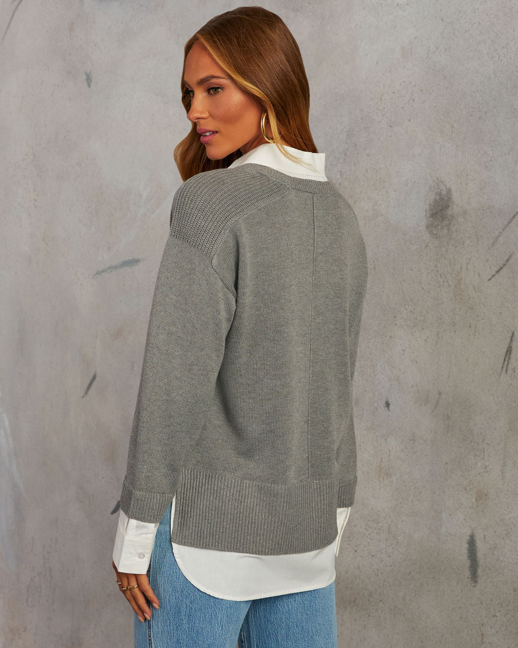Grey V-neck pullover sweater with white contrast shirt hem; long sleeves