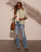 Quilted jacket with full-zip front, stand collar, and two front pockets in light green.