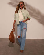Light green quilted jacket with stand collar, full-length sleeves, and zip front.