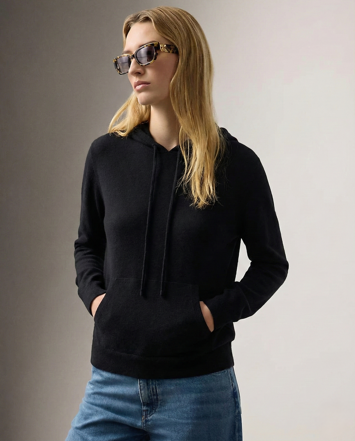 Women’s black pullover hoodie with drawstring hood and front kangaroo pocket