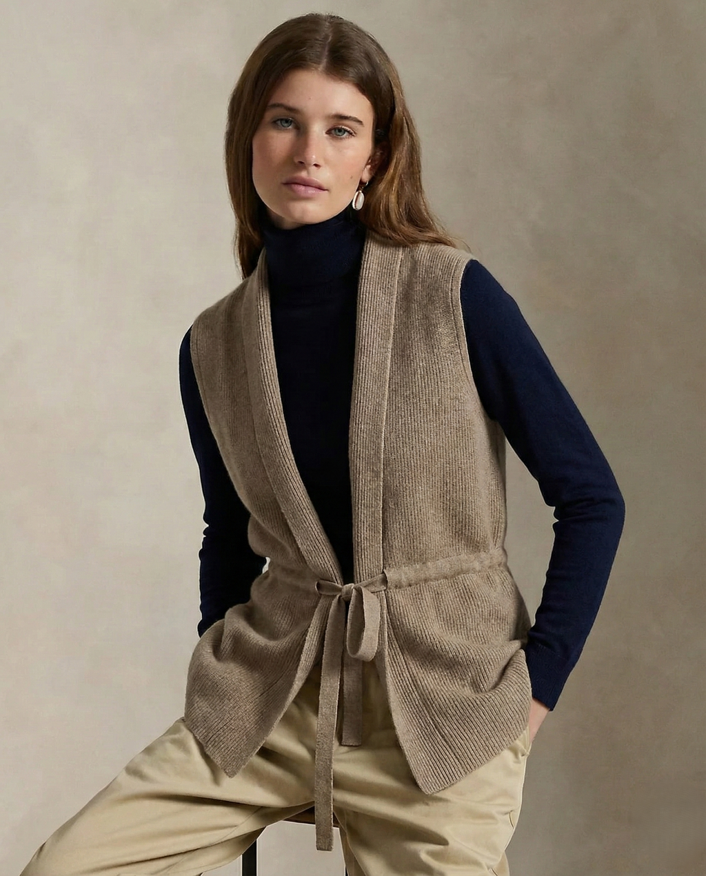 Camel merino wool belted sweater vest, sleeveless V-neck with tie waist detail.