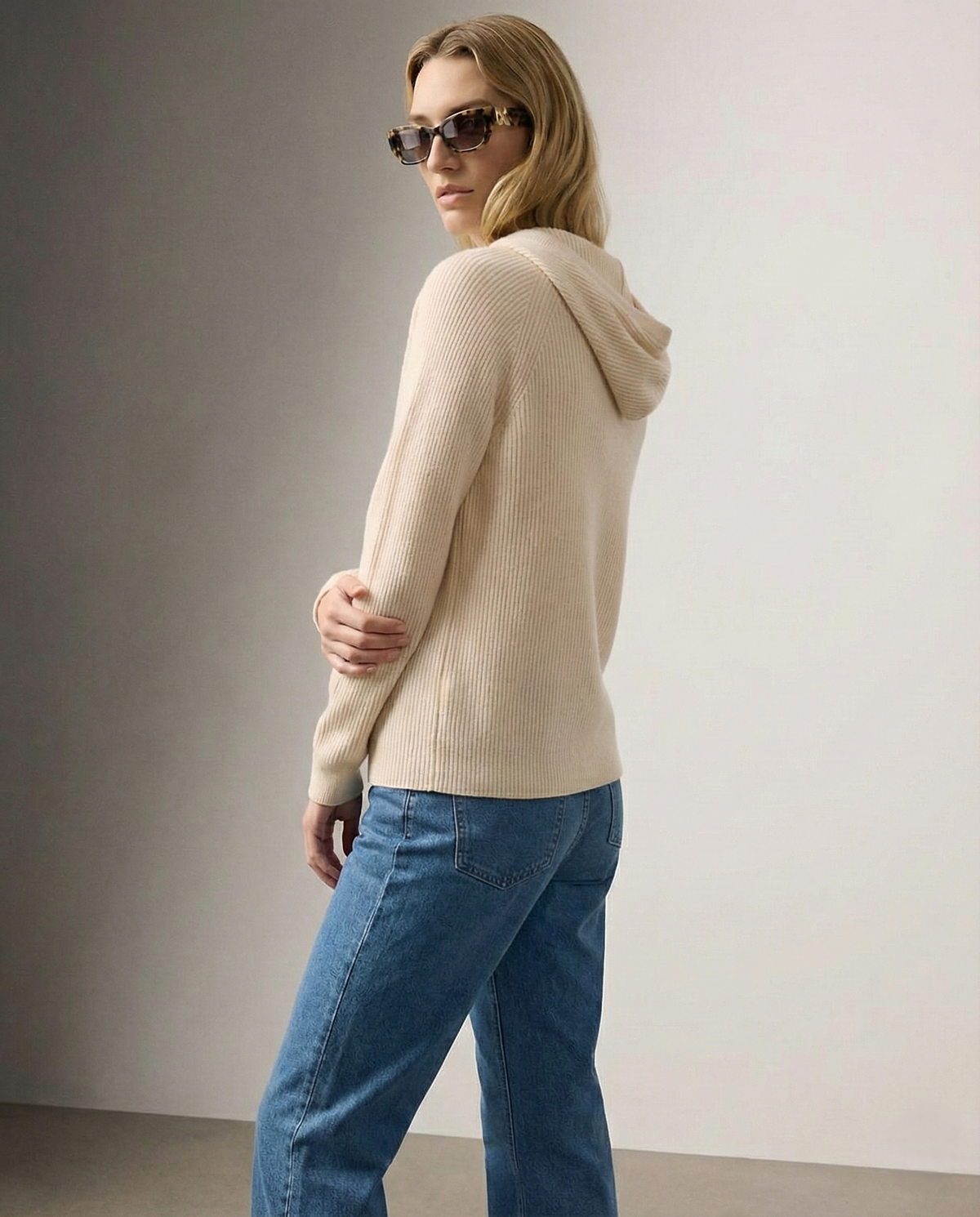 Women's knit hoodie in light beige, back and side view with drawstring hood