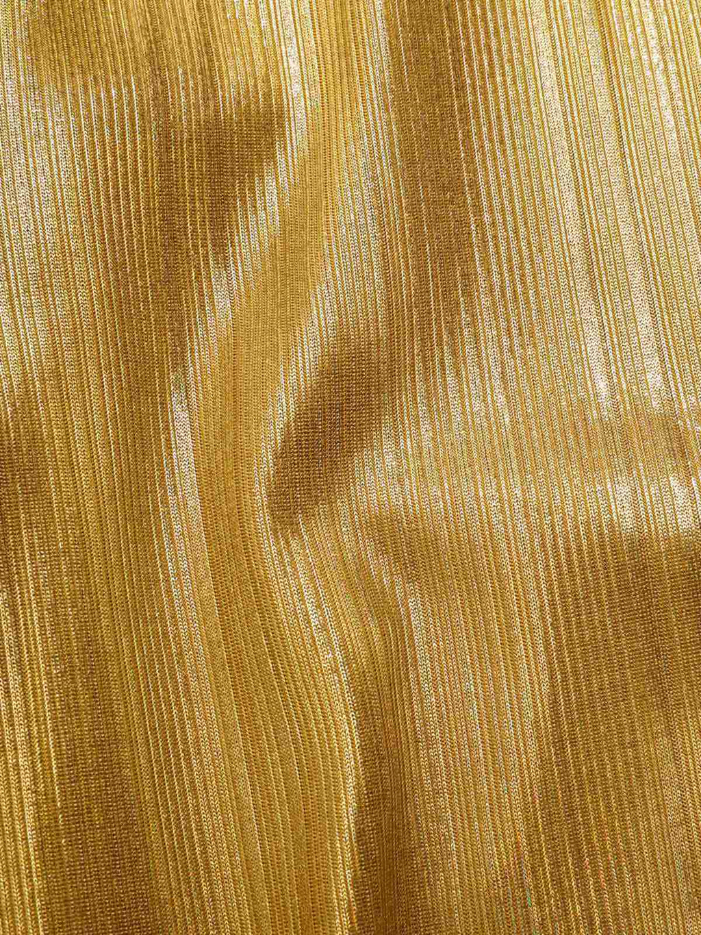 Close-up of shimmering gold fabric with fine vertical texture