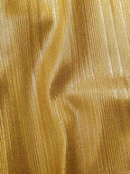 Close-up of shimmering gold fabric with fine vertical texture