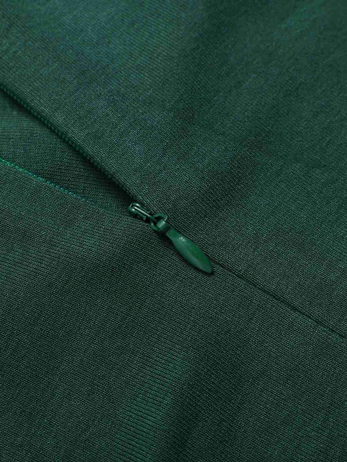 Green placket with small zipper pull detail at neckline