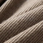 Close-up of striped rib knit texture on a women’s hoodie in brown
