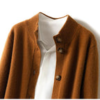 Fire orange button cardigan close-up with round wooden-style buttons.