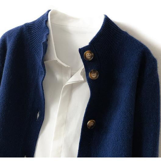 Navy button cardigan sweater close-up with round buttons and ribbed trim.