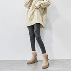Beige suede winter boots with faux-fur lining and side zipper, worn with dark jeans