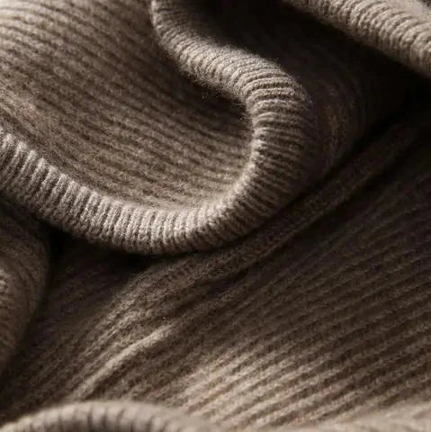 Ribbed front pocket area of a women’s hoodie in dark taupe knit