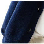 Navy cardigan hem with knit texture and ribbed edge close-up.