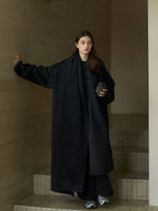 Black wool wrap coat with matching scarf, long silhouette and side pocket