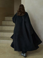 Black wool wrap coat with matching scarf, back view with flared hem