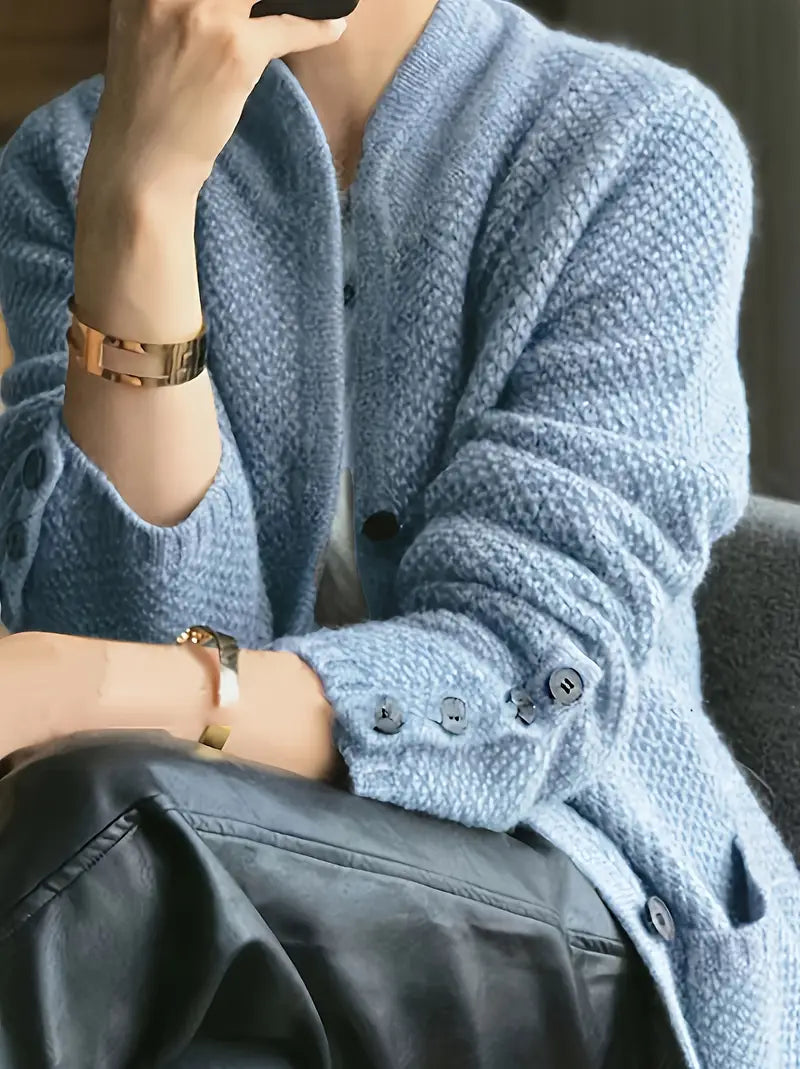 Light blue knit cardigan with button front and dark buttons, long sleeves