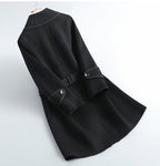 Black overcoat with wide lapels, belt tie, and round button accents