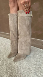 Beige suede tall heeled boots with gold buckle; front view showing shaft height.