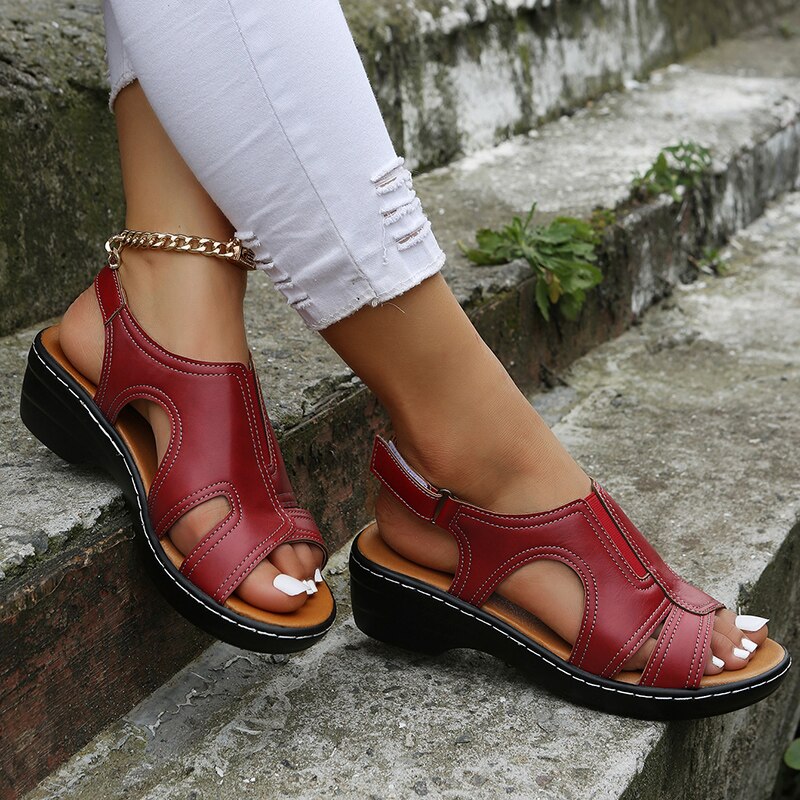 Women’s leather comfort wedge sandals in red with open toe and gold ankle chain strap