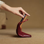 Wine red genuine leather pointed-toe flats with ankle-strap detail and open heel area