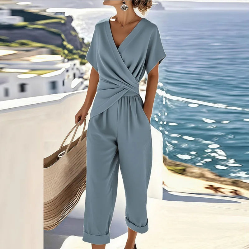 Dusty blue wrap V-neck short-sleeve jumpsuit with tied waist and matching cropped pants