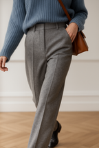 High-waisted gray trousers with belt loops, front seams, and tailored straight-leg cut