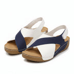 Two-tone blue and white orthopedic wedge sandal with open toe and adjustable strap