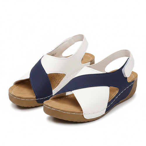 Two-tone blue and white orthopedic wedge sandal with open toe and adjustable strap