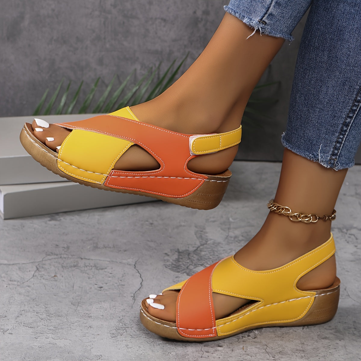 Orange and yellow orthopedic wedge sandal with open toe and padded side strap