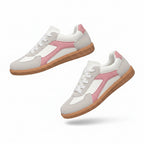 Pink and white low-top sneakers with lace-up front and gum rubber sole