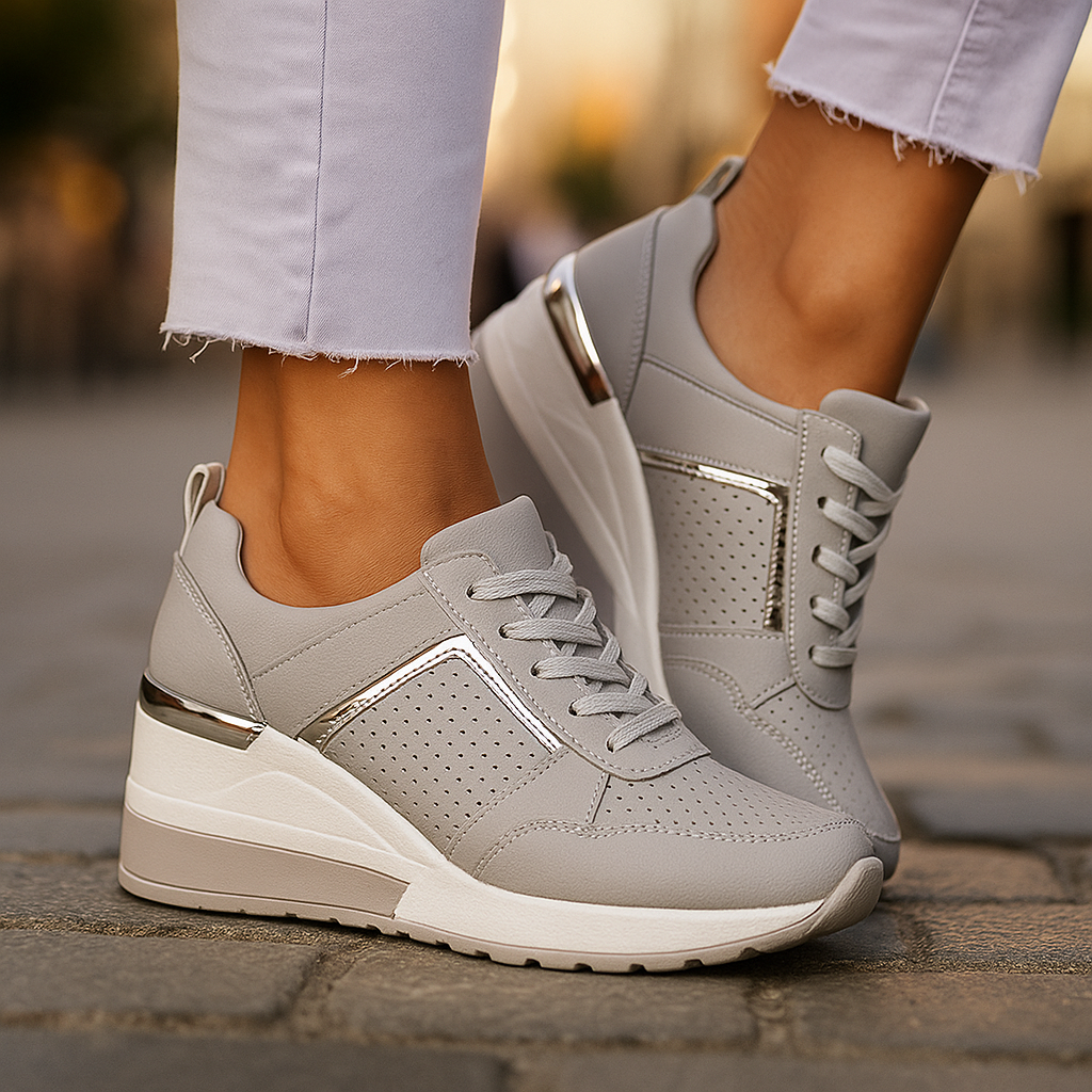 Light gray lift sneakers with perforated sides, gold-tone accents, and lace-up