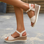 Beige wedge sandal with crisscross straps and jute-style platform