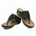 Women's black cutout wedge sandals with adjustable strap and perforated upper