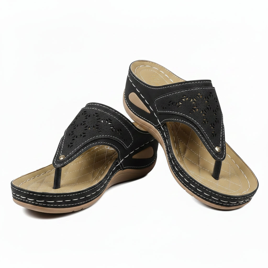 Women's black cutout wedge sandals with adjustable strap and perforated upper