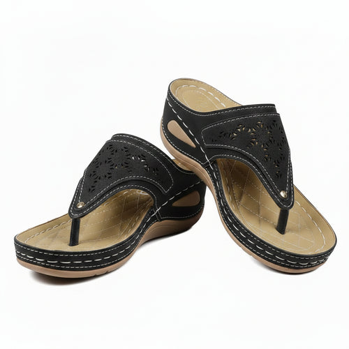 Women's black cutout wedge sandals with adjustable strap and perforated upper