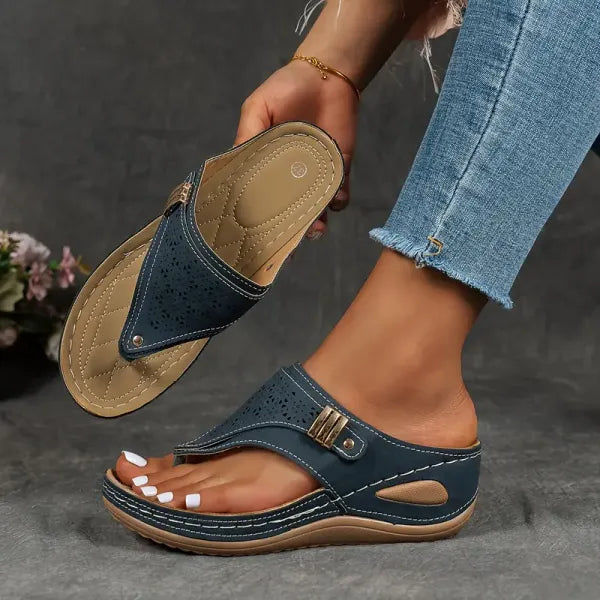 Women's navy cutout wedge sandals with adjustable buckle strap and perforated detailing