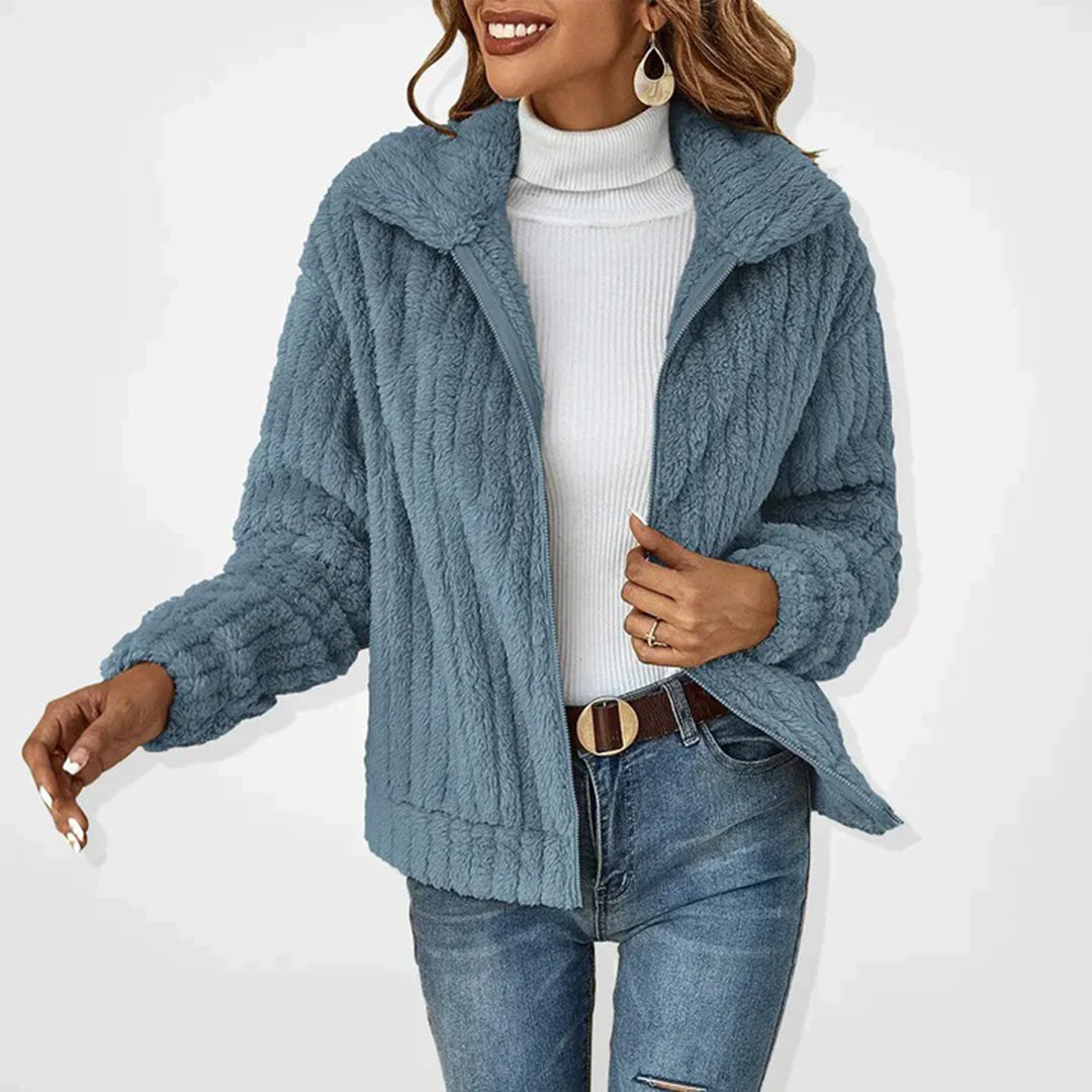 Blue women’s long fleece vest with zip front and high collar, textured cozy fleece