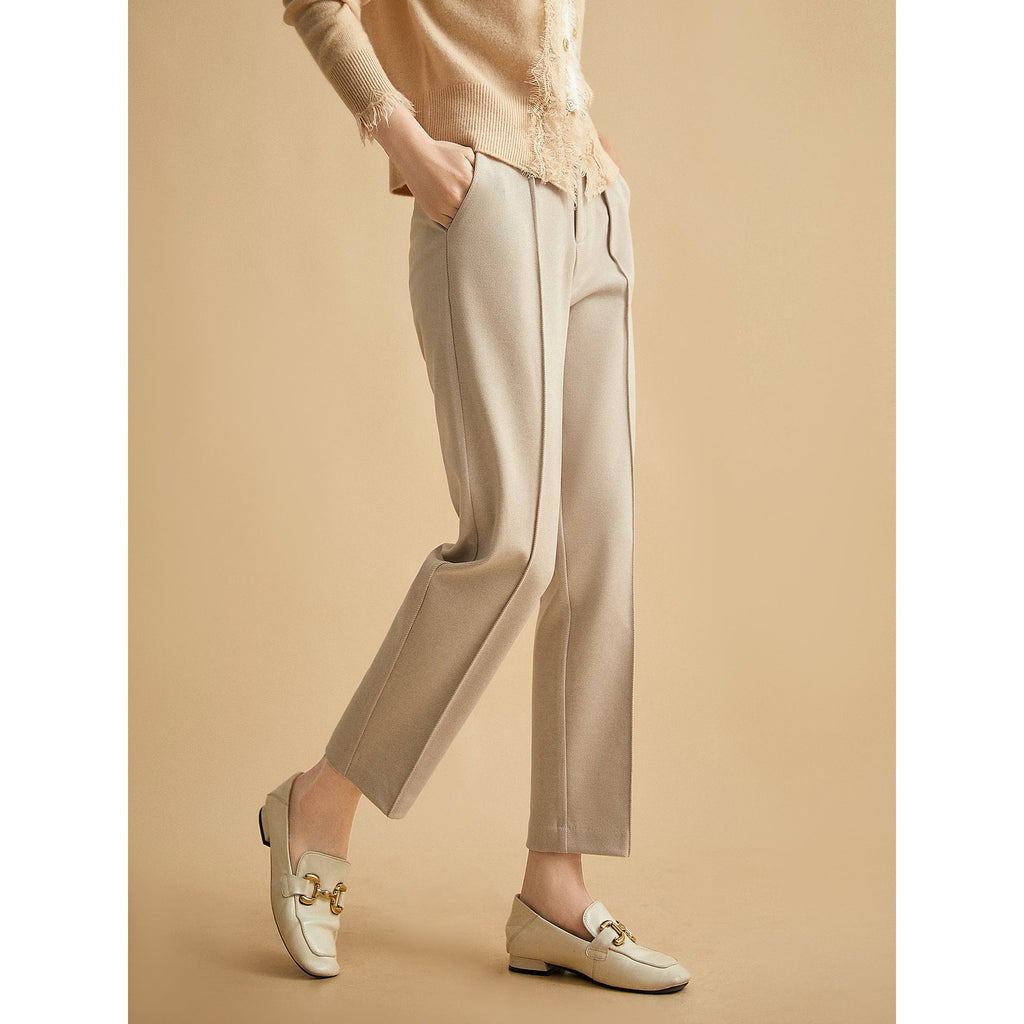 Khaki tapered trousers with high waist, belt loops, and front pleats