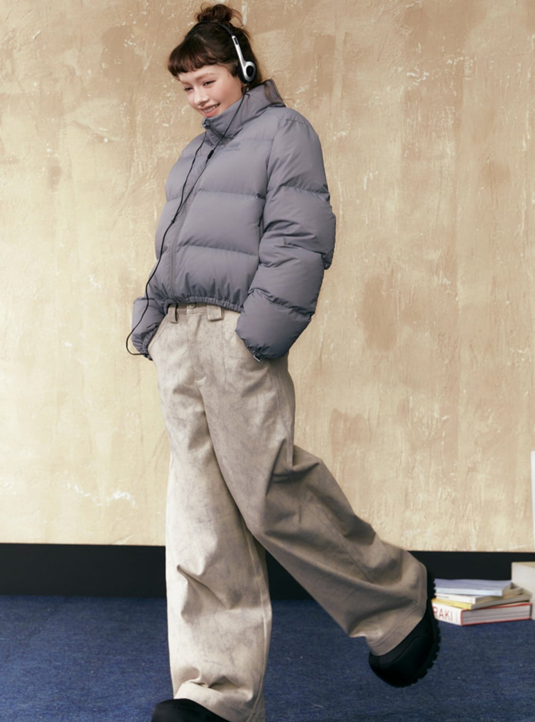 Gray short puffer jacket with stand collar and zip front, elastic hem