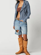 Blue waffle knit zip hoodie worn open over a top; hooded jacket style.