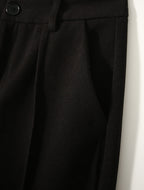 Black high-waisted wool-blend trousers with pleats and button waistband detail
