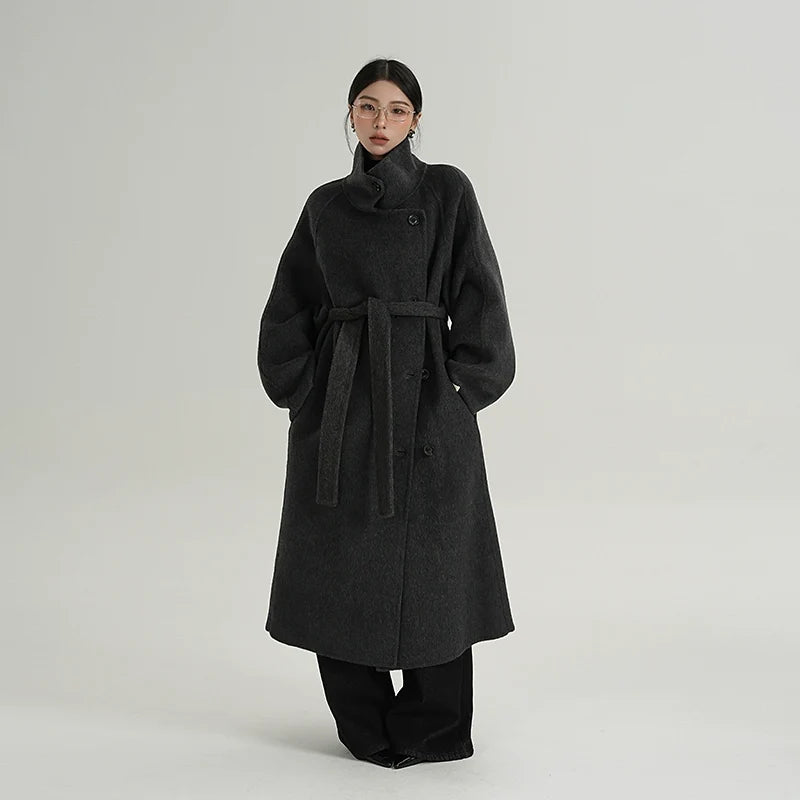 Black funnel-neck wool cocoon coat with tie waist belt and button placket