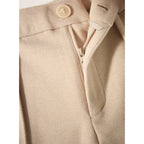 Close-up of beige wool-blend trouser front: button closure and zipper fly