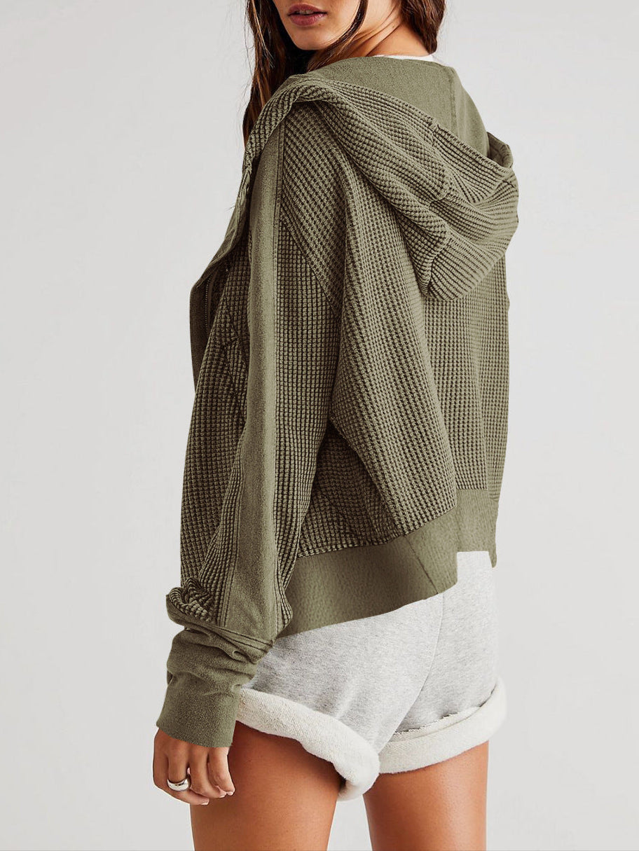 Olive waffle-knit hoodie with hood from the side; ribbed cuffs and curved hem.