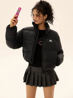 Black short puffer jacket with front pockets, full-zip front, and chest logo