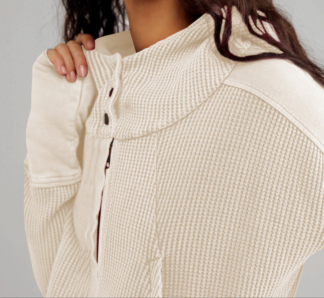 Cream waffle hoodie detail: quarter-zip front with hood and snap closures