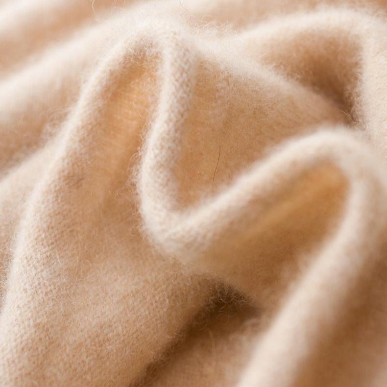Light camel knit texture close-up from a slim fit turtleneck sweater.